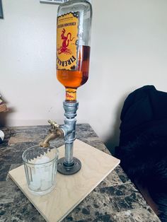 a glass filled with liquid sitting on top of a counter next to a bottle opener