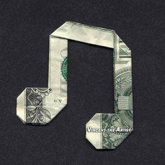 an origami music note made out of money