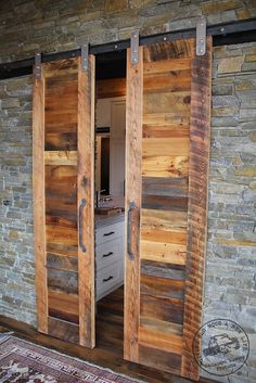 two wooden sliding doors are open in front of a brick wall and rug on the floor