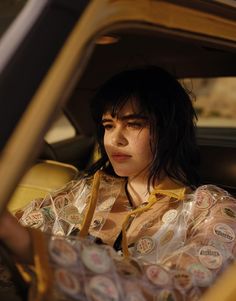 a woman sitting in the back seat of a car