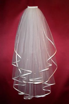 a white wedding veil on a red background