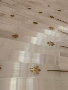 gold florets on the side of a white building