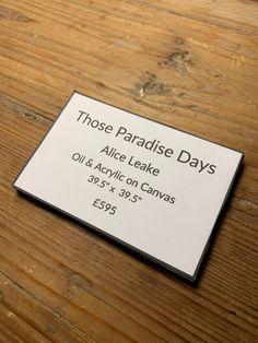 a close up of a business card on a wooden table