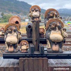 some statues are sitting on top of a train track