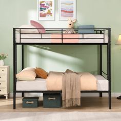 a black metal bunk bed with two drawers and a white mattress underneath it in a green room