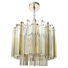 a large chandelier with clear glass tubes hanging from it's center point