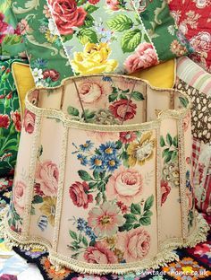 an upholstered lamp shade with flowers on it