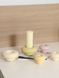 a table topped with candles and doughnuts on top of a white countertop