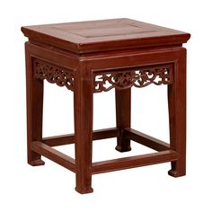 a wooden table with an intricate design on the top and bottom, sitting against a white background