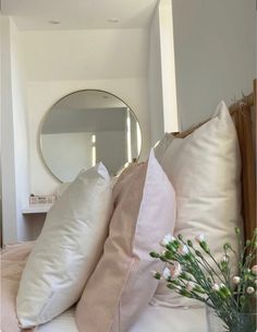 pillows and flowers on a bed in a bedroom