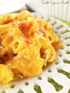 a close up of a plate of food with macaroni and cheese on it