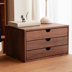 a wooden desk with two drawers and a lamp on top