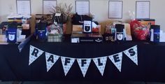 the table is set up with items for raffle's and other merchandise on it