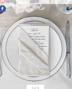 a place setting with napkins, silverware and flowers