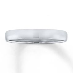 a white gold wedding ring on a plain surface with a slight edge, set in 18k white gold