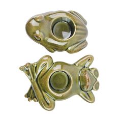 two green ceramic frog figurines sitting next to each other on a white background