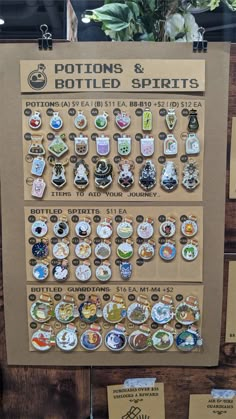 a sign with buttons and badges on it in front of a wooden table full of magnets