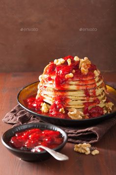 stack of pancakes with strawberry sauce and walnuts - stock photo - images