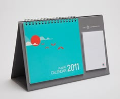 a desk calendar with a notepad attached to it