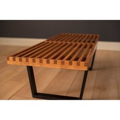 a wooden bench sitting on top of a hard wood floor