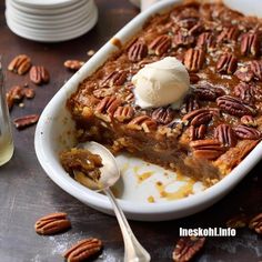 a close up of a plate of food with pecans and ice cream on top