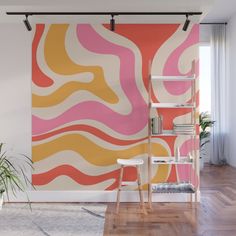 an orange, pink and yellow wall mural in a living room