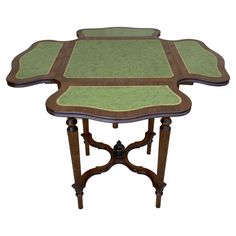 a green and brown table sitting on top of a white floor