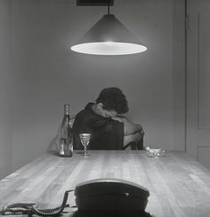 a person sitting at a table with a phone