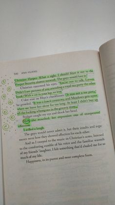 an open book with some green writing on it's page and the inside pages are empty