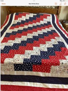 a red, white and blue quilt on a bed