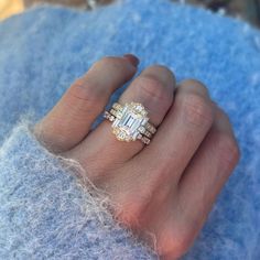 a woman's hand with a ring on it and an engagement band around her finger