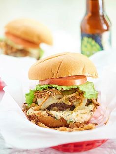 a pulled pork sandwich with coleslaw, carrots and broccoli on a white plate