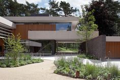 a modern house surrounded by greenery and trees