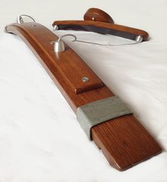 a wooden object with metal handles on a white surface