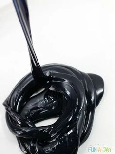 a black liquid is being poured onto a white surface