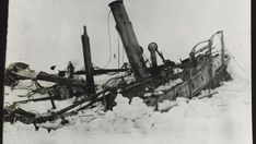 an old black and white photo of a boat in the snow with it's mast missing