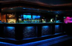 the bar is lit up with blue lights