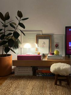 a living room with a couch, coffee table and large screen tv on the wall