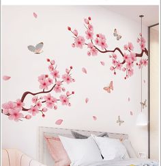 a bedroom with pink flowers and butterflies on the wall