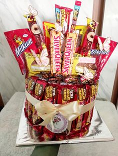 a basket filled with candy and candies on top of a metal tray next to a marble wall