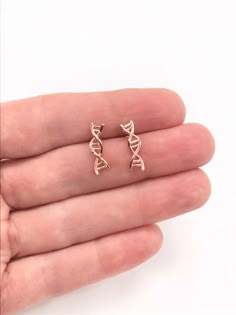 14k Rose Gold DNA Earrings DNA Jewelry DNA Climbers Biology Science Twist Earrings Double Helix Biologist Gift Doctor Gift Science GiftThis DNA earrings is a must for a Biologist, a Doctor or a Nurse, bringing your habit to one more science level in your life and satisfy your nerdy needs!Comes on a beautiful display card ready for gift giving. Add a woven gift bag with a hand tied ribbon and box at checkout!Earrings: 14K Gold Filled or 14k Gold Finish or Sterling Silver or Rhodium (Silver) Finis Biology Earrings, Science Earrings, Dna Earrings, Biology Jewelry, Dna Jewelry, Biology Science, Tied Ribbon, Twist Earrings, Valentines Bracelets