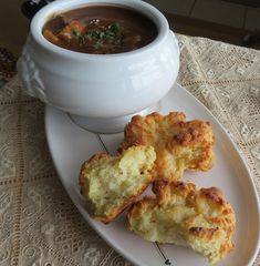 some biscuits and soup on a white plate