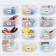 plastic storage containers with labels on them are organized and labeled for the classroom to use