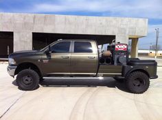 a large truck parked in front of a building with a parking meter on it's side