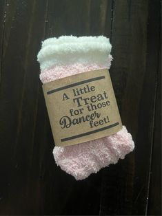 a little treat for those dancer feet is wrapped in pink and white yarn with a brown tag