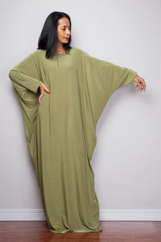 "Olive Green Kaftan Dress, Maxi Dress, Long boho dress, Loose fit dress, Modest dress, Green kaftan with pockets PRODUCT SIZE : One Size Fits Most * Chest : free up to 58\" * Waist : free up to 58\" * Hips : free up to 58\" * Circumference bottom hem : 45\" * Length : 56\" * Sleeve length : 23\" MATERIAL * Spandex Venetia * Zipper on the back MODEL : * Model chest : 32\", Height 160 cm (5.2) without high heel * Accessories excluded Produced by NUICHAN IMPORTANT NOTE *Please note that colours sho Free Size Green Maxi Dress, Green Free Size Maxi Dress, Green Boho Tunic Dress, Oversized Tunic Abaya, Oversized Bohemian Maxi Dress With Batwing Sleeves, Oversized Long Sleeve Abaya For The Beach, Green Bohemian Abaya With V-neck, Casual Long Green Maxi Dress, Casual Green Flowy Boho Dress