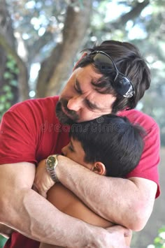 a father hugging his son in the park stock photo - image 349784