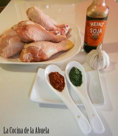 the ingredients are laid out on the table to be used in this recipe, including raw chicken