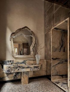 a marble table and mirror in a room