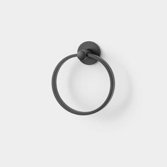 a black towel ring on a white wall